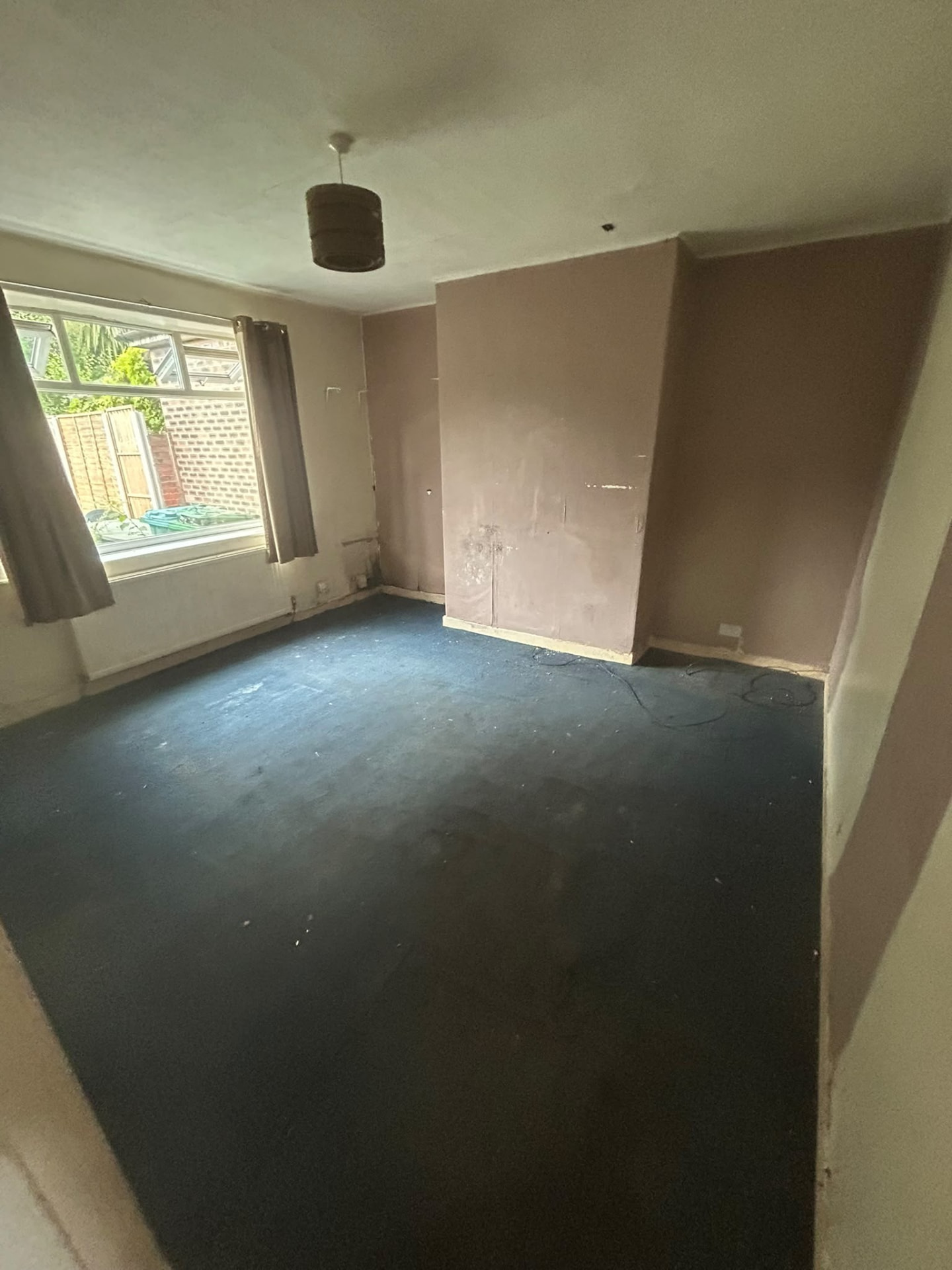 Manchester bedroom emptied during a full house clearance, leaving bare carpet and clean walls