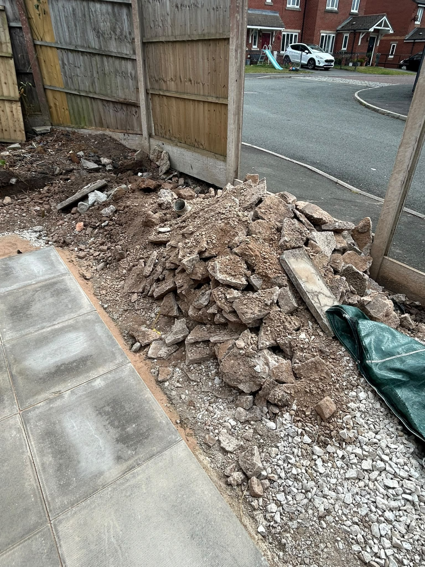 Broken concrete and hardcore stacked outside a Manchester property during a strip out and rubble removal